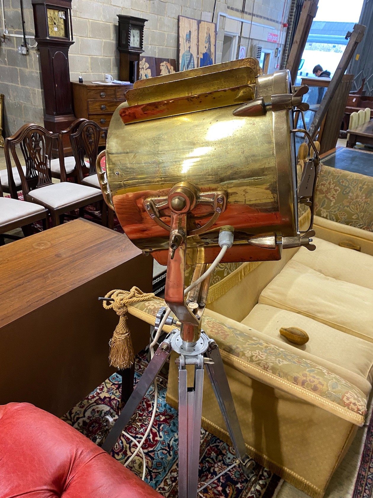 A vintage style brass spotlight floor lamp on tripod stand, height 152cm